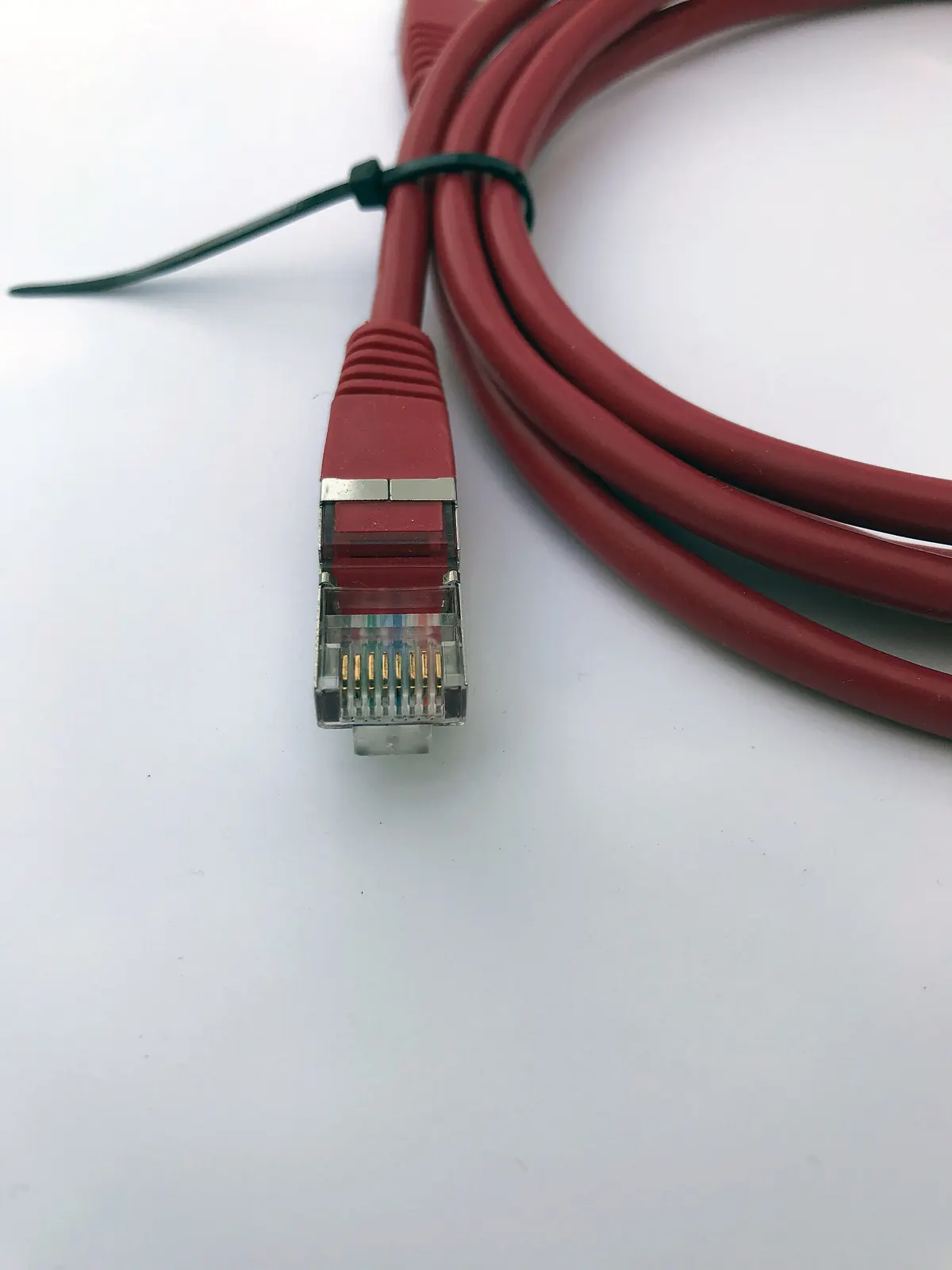 A red Ethernet patch cable with an RJ45 connector, the simplest upgrade for stable IPTV playback